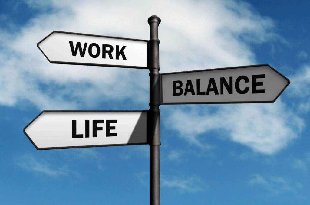 A close-up shot of the work life balance sign post